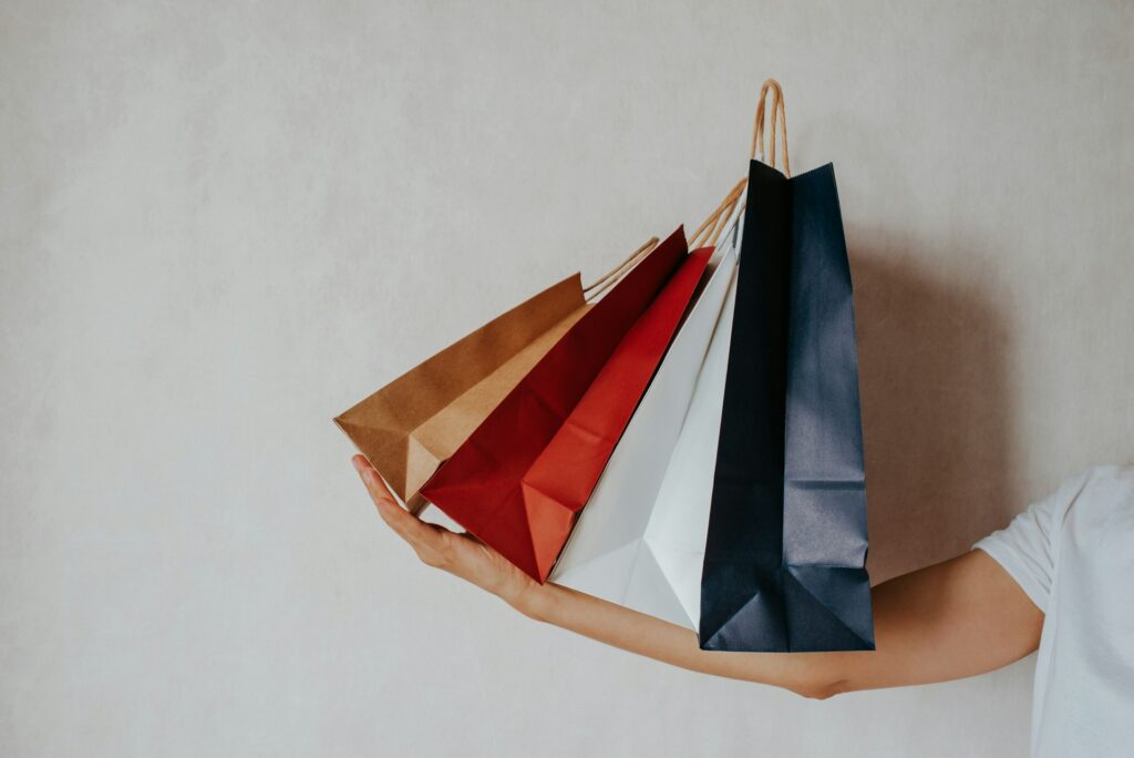 Colourful paper shopping bags in kraft, red, white and navy